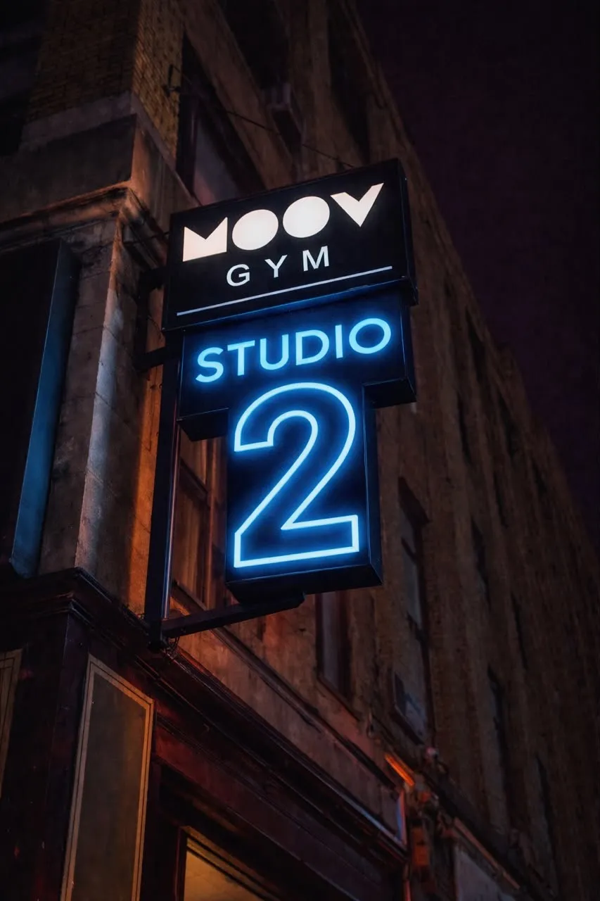 Moov Gym’s Studio 2 signboard glowing blue outside the building